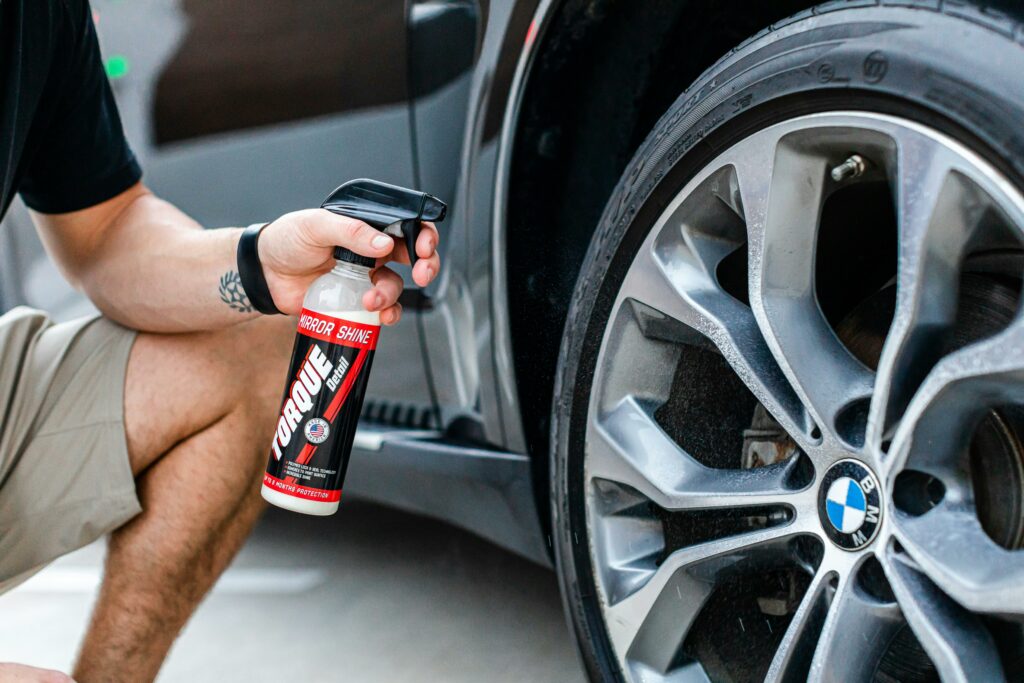 Man Hand Spraying a Car Wheel